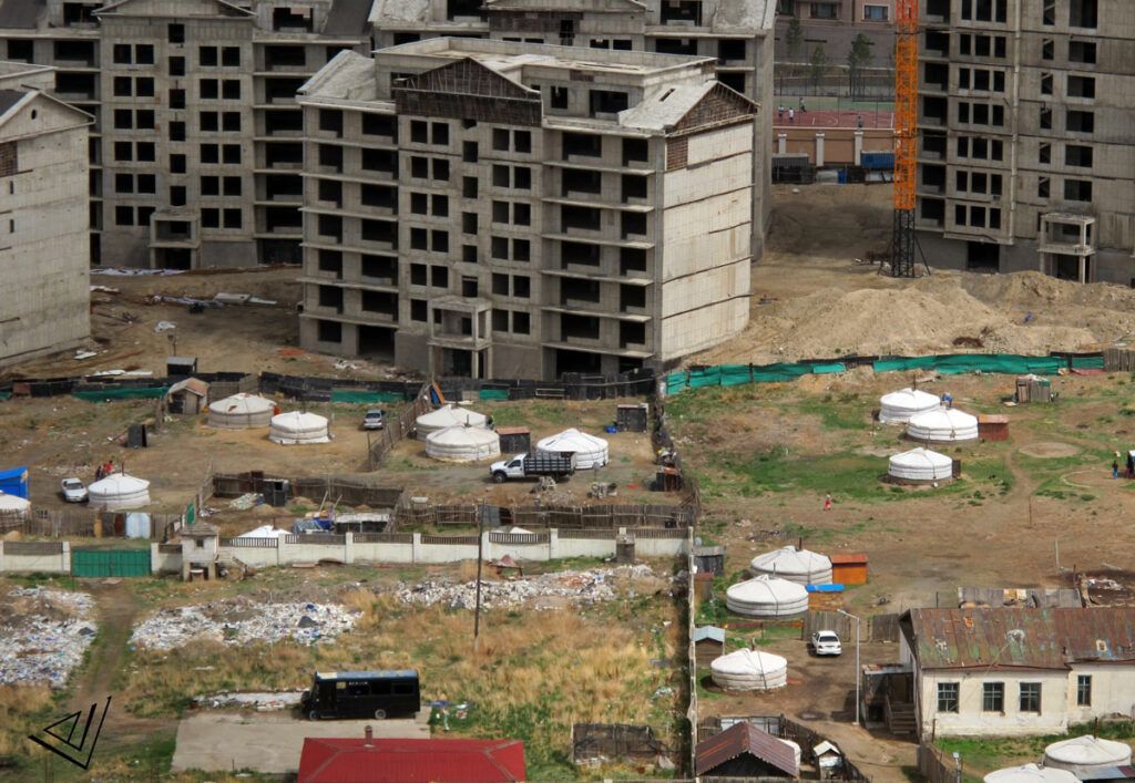 new apartment building being built in city, surrounded by gers