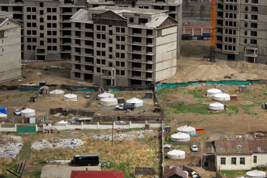 new apartment building being built in city, surrounded by gers