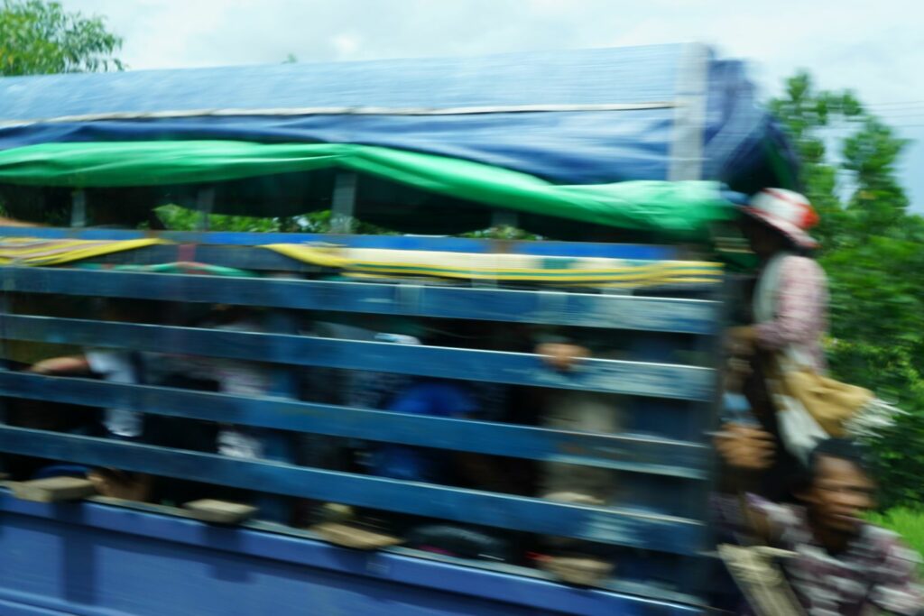 people being driven on a van