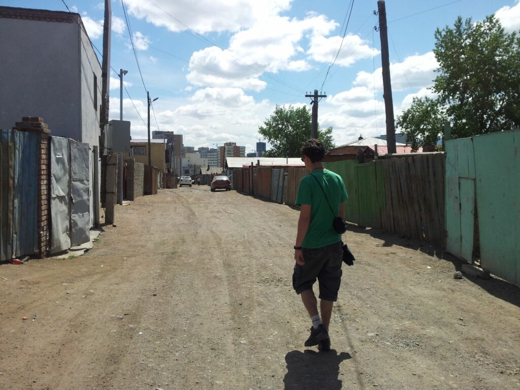 man walks on gravel street